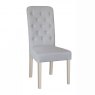 Stylish button back chair with painted legs is available upholstered in leather or fabric.