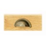Brass cup handles for drawers.